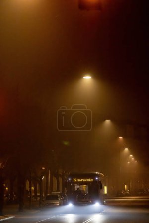 Photo for Copenhagen, Denmark A bus on Frederiksberg Alle at night in the fog. - Royalty Free Image