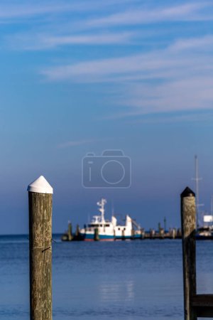 Foto de Solomons, Maryland ,USA White- topped pylons in a marina on the Patuxent River and a boat. - Imagen libre de derechos