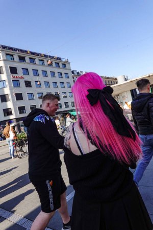 Photo for Copenhagen, Denmark A young woman with pink and purple hair on the Norreport  Square - Royalty Free Image