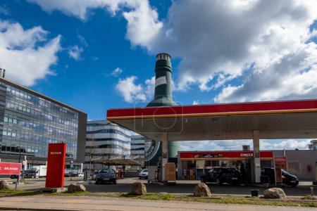 Photo for Copenhagen, Denmark A super-sized inflatable Tuborg beer bottle stands behind a gas station at the Turborg world headquarters in Copenhagen. - Royalty Free Image