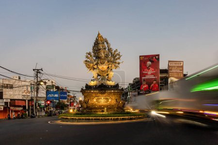 Photo for Denpasar, Bali, Indonesia Traffic around the Patung Wisnu Murti statue - Royalty Free Image