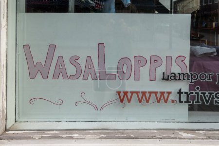 Photo for Mora, Sweden July 13, 2023 A sign in a second hand shop window says WasaLoppis, a play on words on Vasaloppet, the ski race, as loppis means second hand. - Royalty Free Image