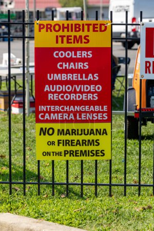 Photo for Solomons, Maryland, USA July 27, 2023 A sign on a lawn prohibits items and says No Marijuana, No firearms, and no tailgating, no coolers, no umbrella, - Royalty Free Image