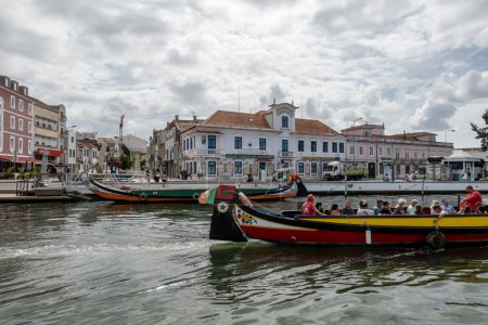 Photo for Aveiro, Portugal Sept 20, 2023 People riding the historic wooden salt boats on the city's canals. - Royalty Free Image