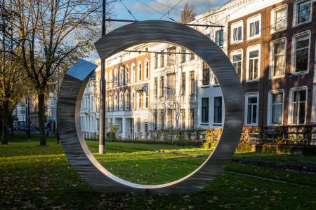 Photo for Rotterdam, Netherlands, Nov 11, 2023 A polished steel ring by Frans and Marja de Boer Lichtveld from 1985 on an art walk through the city called the Beeldenroute Westewrsingel. - Royalty Free Image