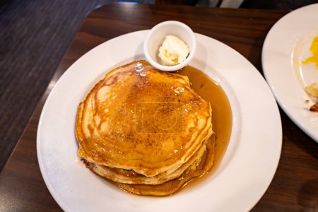 Photo for Prince Frederick, Maryland USA A stack of pancakes with a side dish of butter and maple syrup. - Royalty Free Image
