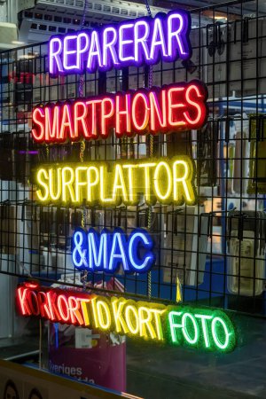 Photo for Stockholm, Sweden Dec 29, 2023 A window display of an electronics and phone store says in Swedish Repair, Smartphones, tablets, Macs, and ID photos - Royalty Free Image