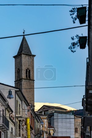 Pacentro, Italy The Chiesa di Santa Maria Maggiore church tower and snow covered mountain in the downtown