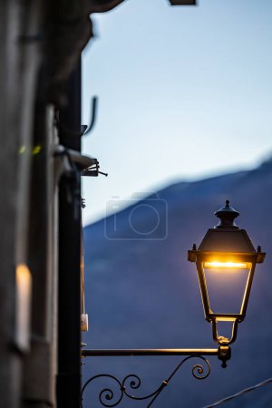 Secinaro, Italy A street lamp and a mountain in the background.