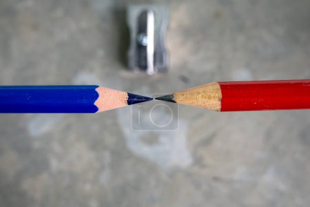 Photo for Red and blue pencils and a pencil sharpener. - Royalty Free Image
