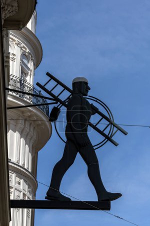 Photo for Vienna, Austria April 5, 2024 The silhouette shape of a male chimney sweep  carrying a ladder on Wipplingerstrasse in - Royalty Free Image