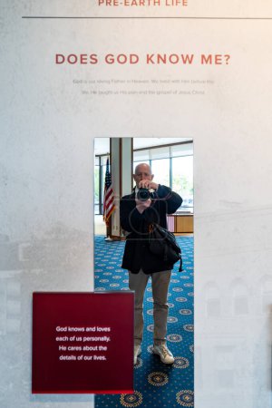 Photo for Kensington, Maryland April 24, 2024   A display at the Mormon Temple, or the Washington D.C. Temple and a visitor reflected in a mirror - Royalty Free Image