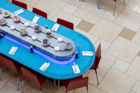 Sushi boats on a carousel in a restaurant.