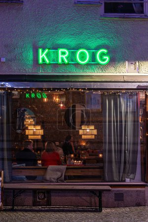 Photo for Stockholm, Sweden May 9, 2024 A restaurant and guests and sign in Swedish says Krog or restaurant in the Hokarangen suburb. - Royalty Free Image