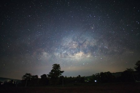 Photo for Milky Way and silhouette of tree at Phitsanulok Thailand, Long exposure photograph.with grain - Royalty Free Image