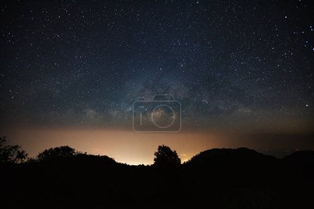 Photo for Milkyway galaxy over moutain with city light and space dust in the universe - Royalty Free Image