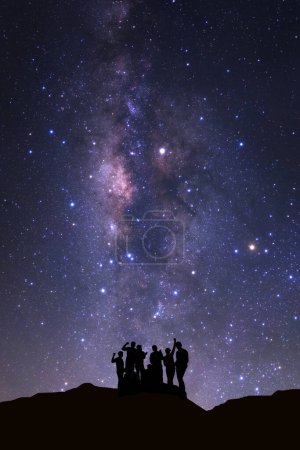 Photo for Landscape with milky way, Night sky with stars and silhouette of happy people standing on high moutain - Royalty Free Image