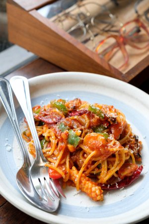spaghetti seafood tomato sauce on wood table