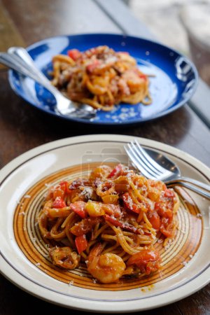 spaghetti seafood tomato sauce on wood table
