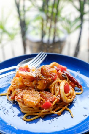 Photo for Spaghetti seafood tomato sauce on wood table - Royalty Free Image