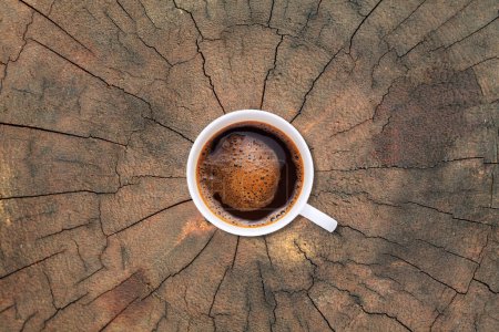 Photo for A cup of coffee on old tree stump texture backgroun - Royalty Free Image
