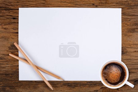 Photo for Blank paper and a cup of coffee on woode - Royalty Free Image