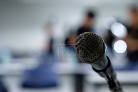 Photo for Microphone on the abstract blurred photo of seminar room background - Royalty Free Image