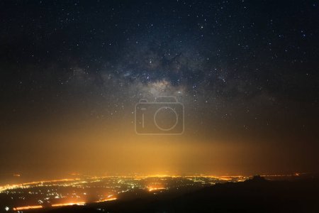 Photo for Milky way galaxy with stars and space dust in the universe and city light at Phutabberk Phetchabun in Thailand. - Royalty Free Image