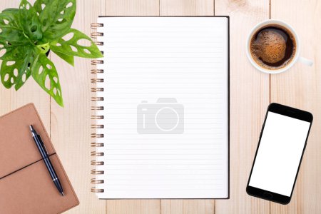 Photo for An open blank notebook, smartphone with pen and a cup of coffee on wooden table - Royalty Free Image