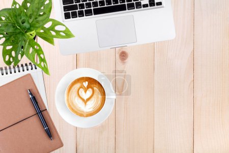 Photo for Modern workspace with laptop tablet,notebook and coffee cup copy space on wood table background. Top view. Flat lay style. - Royalty Free Image