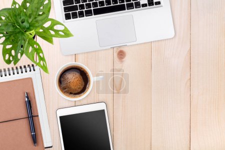 Photo for Modern workspace with laptop tablet,notebook and coffee cup copy space on wood table background. Top view. Flat lay style. - Royalty Free Image