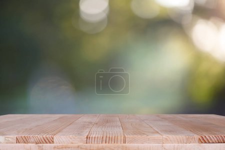 Photo for Wood table top on bokeh green background - can be used for montage or display your products - Royalty Free Image