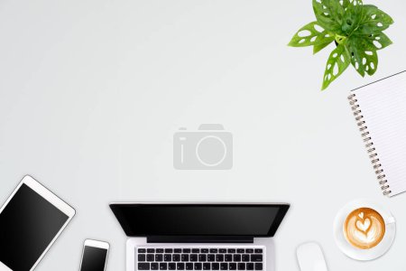 Photo for Modern workspace with laptop tablet, smartphone and coffee cup copy space on color background. Top view. Flat lay style. - Royalty Free Image