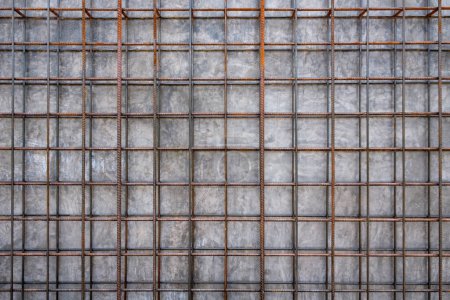 metal steel reinforcing rods lattice and concrete wall background