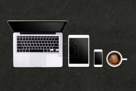 Photo for Laptop tablet smartphone  and coffee on black table background with text space and copy space - Royalty Free Image