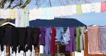 Las prendas coloridas, el vestido y los pantalones que cuelgan en una línea de ropa cerca de Quaryville, Pennsylvania, EE.UU.