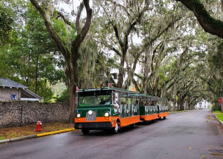 Photo for St Augustine, Florida, U.S - November 18, 2023 - The Old Town Trolley Tours moving on the street - Royalty Free Image