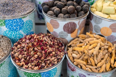 Photo for Closeup of buckets with turmeric and dry rose buds spice in Dubai market - Royalty Free Image