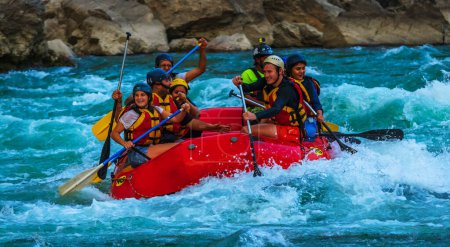 Photo for Young persons rafting on the river Ganges in Rishikesh India, extreme and fun sport at tourist attraction - Royalty Free Image