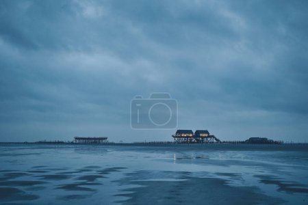stilt house at sankt peter-ording germany on dark overcast day. High quality photo