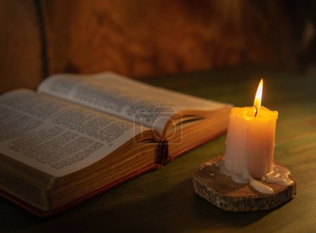 Photo for Bible lit with a candle religion and message concept - Royalty Free Image