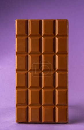 chocolate bar isolated on purple background. International chocolate day concept