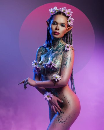 A charming female elf. One with nature and organically purity. The nude model her body covered flowers and sparkle glitter. On a magical background with smoke. Natural care or treatment for the body
