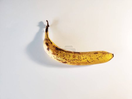 Photo for Photo of Single Overripe Banana on White Background - Royalty Free Image
