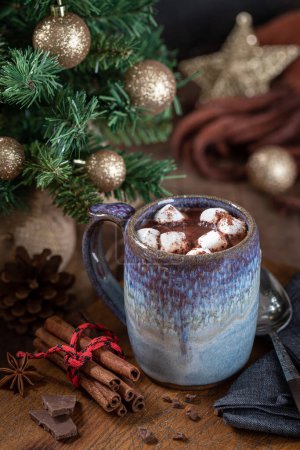 Téléchargez les photos : Tasse de chocolat chaud et guimauves sur une table en bois avec des décorations de Noël en arrière-plan - en image libre de droit
