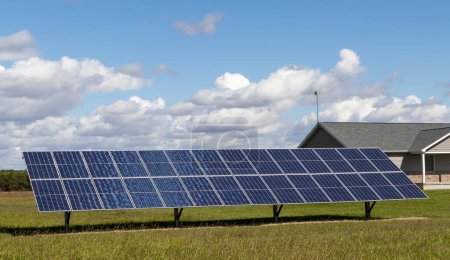 Photo for Solar power panels for generating electricity in rural area with partly cloudy sky - Royalty Free Image