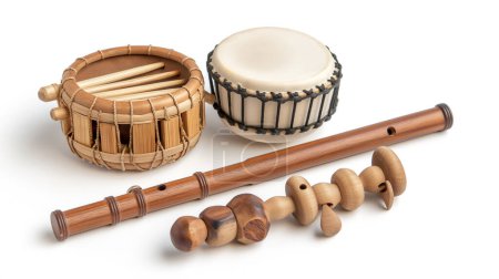 Traditional musical instruments including a drum, a bamboo flute, and wooden rattles on a white background.