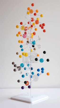 A colorful molecular model structure on a white stand and background.