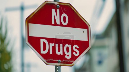 A red and white "No Drugs" sign, prominently displayed.