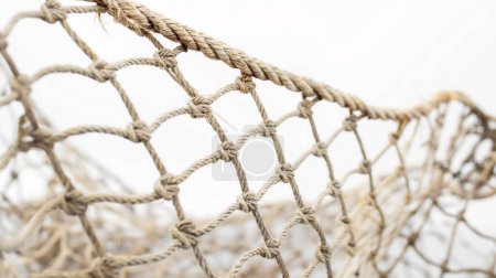 Photo for Close-up of a section of beige fishing net, knotted and interwoven. - Royalty Free Image